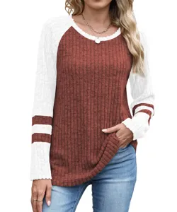 Close-up detail of women's contrast color waffle knit long sleeve top with crew neck.