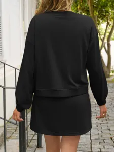 Back view detail of casual solid black long sleeve sweatshirt and skirt two-piece set.
