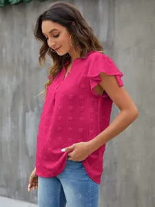 Detail shot of women's V-neck ruffle short sleeve dot chiffon top in bright magenta color.