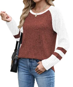 Close-up detail of women color-block raglan sleeve knit top with textured ribbed fabric.