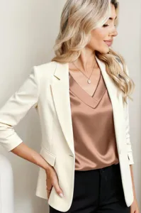 Close-up detail of a stylish satin V-neck top paired with a chic white blazer for women.
