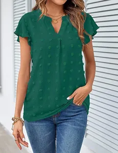 Green V-neck ruffle short sleeve swiss dot blouse detail view showing textured fabric.