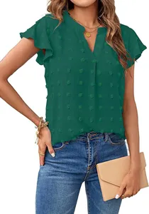 Close-up detail of the dark green V-neck swiss dot blouse sleeve and texture fabric.