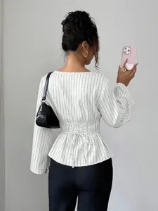 Detail view of a stylish women's long sleeve striped blouse featuring an elegant lace-up back design.