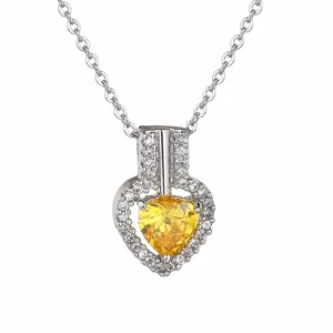 Detailed view of silver heart pendant necklace with dazzling yellow zircon stone and pave setting.
