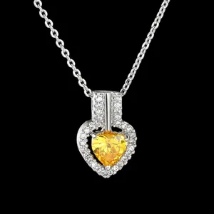 Detailed close-up of a sparkling heart-shaped yellow cubic zirconia pendant necklace.