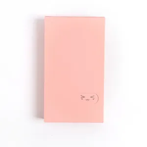 Detailed closeup of a cute pink solid color card holder and business card organizer album.