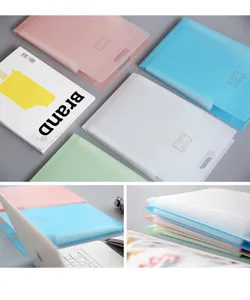 Close-up detail of multi-layer A4 accordion file folders in pastel colors on a clean desk.