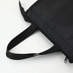 Black oxford cloth insulated lunch bag detail view showing handle and zipper quality.