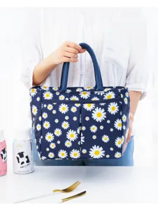 Detail view of the blue floral insulated lunch bag featuring cute white daisy print.
