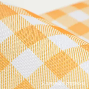 Close-up detail of orange and white checkered picnic basket fabric texture and pattern.