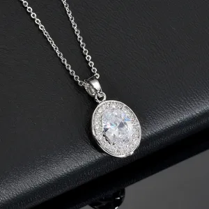 Close-up of sparkling oval cubic zirconia halo pendant necklace with silver-toned chain detail.