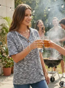 Summer women waffle knit short sleeve hoodie top detail view in outdoor barbecue scene.