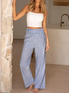 Detailed view of women's blue and white gingham high waisted wide leg casual pants indoor.