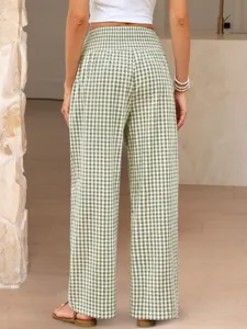 Back view detail of high-waisted green and white gingham wide-leg pants in modern indoor setting.