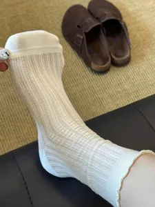 Sheer mid-tube socks with delicate lettuce trim, perfect for balletcore styling.