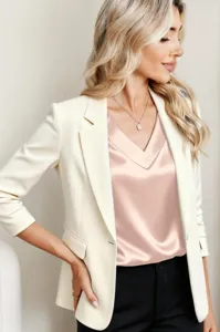 Detailed shot of a stylish women satin V-neck top paired with a white blazer outfit.