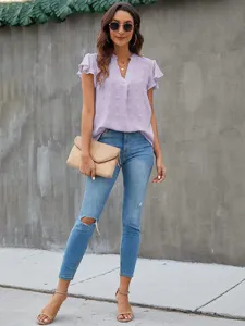 Detail view of the elegant V-neck swiss dot short sleeve chiffon blouse in light purple.