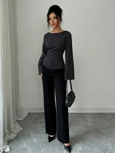 Detailed look at the striped long sleeve top paired with stylish black wide-leg pants