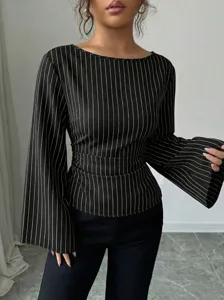 Close-up detail of women's black and white pinstriped long sleeve flare cuff blouse top.