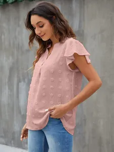 Close-up detail of women pink v-neck flutter sleeve chiffon top with cute pom pom texture.