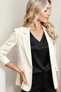 Elegant off-white blazer paired with a sleek black satin V-neck top for women's fashion wear.