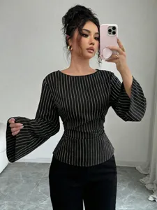 Detail shot of black and white striped long sleeve top with chic flared cuffs and slim fit.