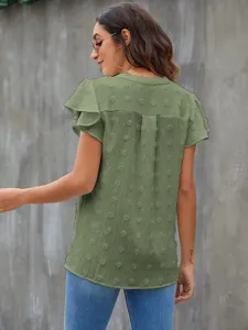 Green short sleeve v-neck ruffle dot blouse detail view showcasing the textured chiffon fabric.