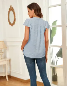Back view detail of the elegant light blue swiss dot ruffle sleeve V-neck blouse in room.