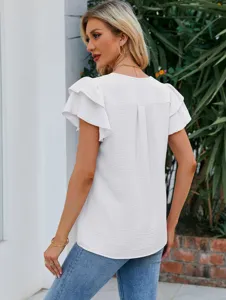 Vue détaillée montrant le pli dorsal et les manches papillon superposées de ce top blanc.