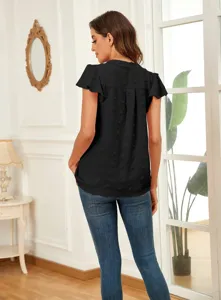 Detail view of black swiss dot V-neck short sleeve blouse with elegant flutter ruffles.