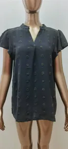 Detail view of the V-neck pom-pom chiffon top with ruffle sleeves and textured polka dots.