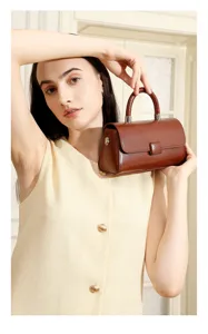 Close up of chic brown leather handbag detail, stylish compact shoulder bag for women.