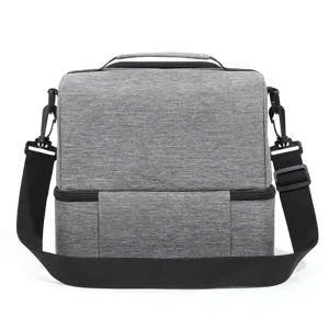 Gray insulated lunch bag with double decker design, adjustable shoulder strap and durable fabric.