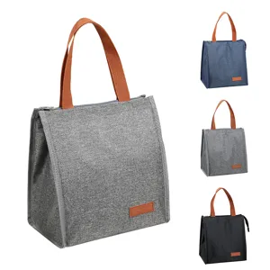 Close-up of insulated lunch bag in multiple colors, featuring durable fabric and sturdy handles.