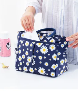 Detail view of a blue daisy print insulated lunch bag with front pocket for daily use.
