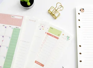 Detail shot of colorful A6 binder planner refills, featuring monthly, daily and to-do layouts.