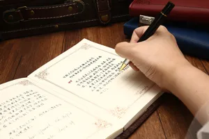 Close-up detail shot of writing inside a vintage A5 notebook with retro aesthetic stationery.