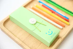 Minimalist candy color PP plastic pencil box with elastic string closure and cute smile design