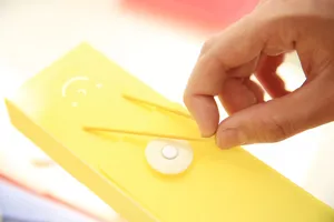 Close-up detail of yellow PP frosted stationery pencil box with elastic band and button clasp.
