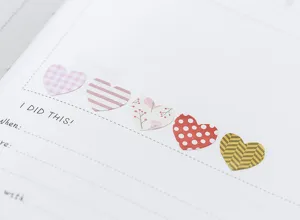 Close-up detail of colorful heart-shaped journal stickers arranged neatly on paper.