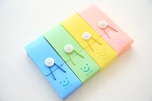 Detailed view of colorful candy plastic pencil cases with elastic band and cute smile design.