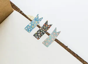 Close-up detail of vintage floral magnetic bookmarks clipped on open journal page