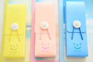 Candy color student pencil box with elastic buckle and cute smile design for school.