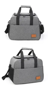 Gray insulated lunch bag close-up showing dual handles, front pocket, and durable zippers.