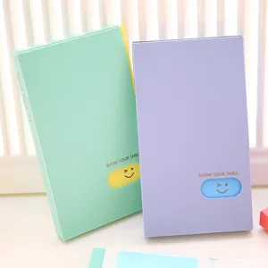 Cute pastel PP business card holder book with smile design, large capacity 120 card slots.