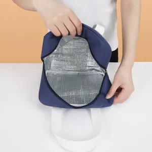 Insulated lunch bag with durable blue exterior and silver foil interior for daily meals.