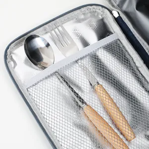 Insulated lunch bag interior detail showing mesh pocket and cutlery set for outdoor meals.