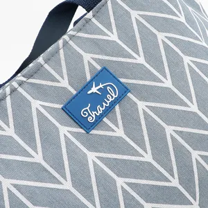 Close-up detail of Nordic style grey chevron insulated lunch bag fabric and travel label.