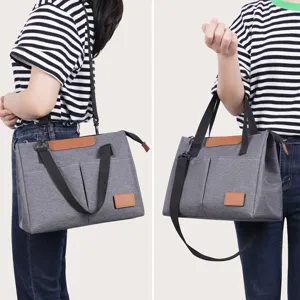 Grey insulated lunch bag portable canvas cross-body tote bag for outdoor daily use and travel.